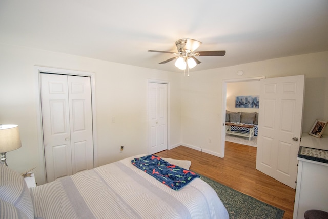 108 Central Ct, Richmond, KY 40475 - bedroom with multiple closets, light wood-style floors, ceiling fan, and baseboards