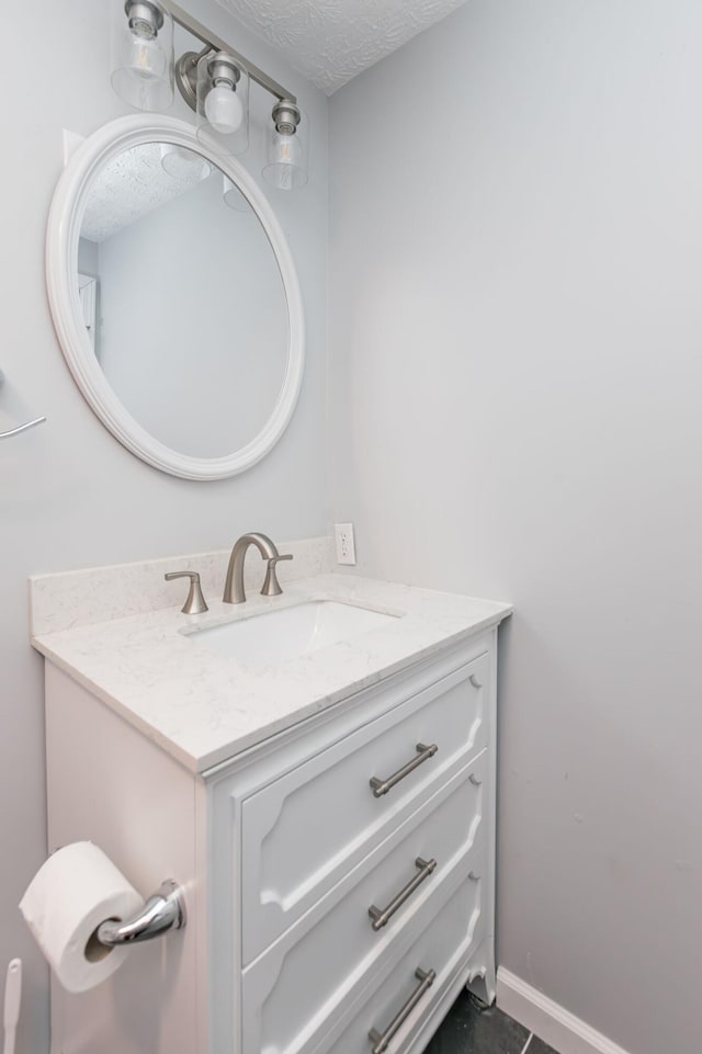bathroom with vanity and a textured ceiling