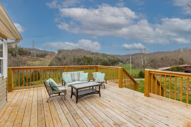wooden terrace with an outdoor living space and a mountain view