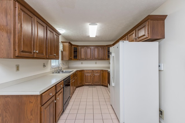 122 Barker Way, Lancaster, KY 40444 - kitchen with freestanding refrigerator, a sink, dishwasher, light tile patterned floors, and brown cabinetry