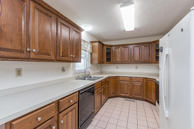 122 Barker Way, Lancaster, KY 40444 - kitchen featuring black dishwasher, freestanding refrigerator, a sink, light tile patterned floors, and brown cabinetry