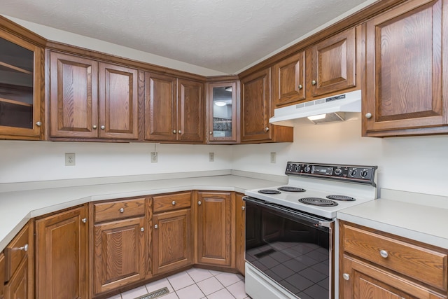 122 Barker Way, Lancaster, KY 40444 - kitchen featuring electric stove, under cabinet range hood, light tile patterned floors, light countertops, and glass insert cabinets