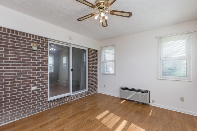 122 Barker Way, Lancaster, KY 40444 - unfurnished room with wood finished floors, baseboards, a textured ceiling, a ceiling fan, and heating unit