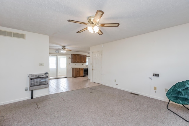 122 Barker Way, Lancaster, KY 40444 - unfurnished living room featuring heating unit, a ceiling fan, baseboards, light carpet, and a textured ceiling
