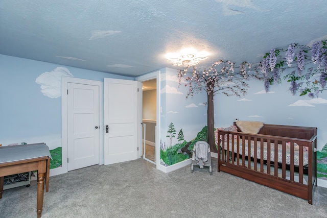 bedroom featuring a textured ceiling, carpet floors, and baseboards