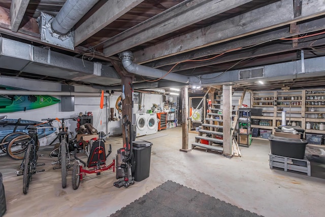 unfinished below grade area with visible vents, stairs, and washing machine and dryer