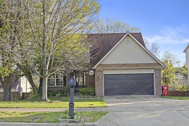 traditional-style home featuring a front yard, a garage, brick siding, fence, and concrete driveway