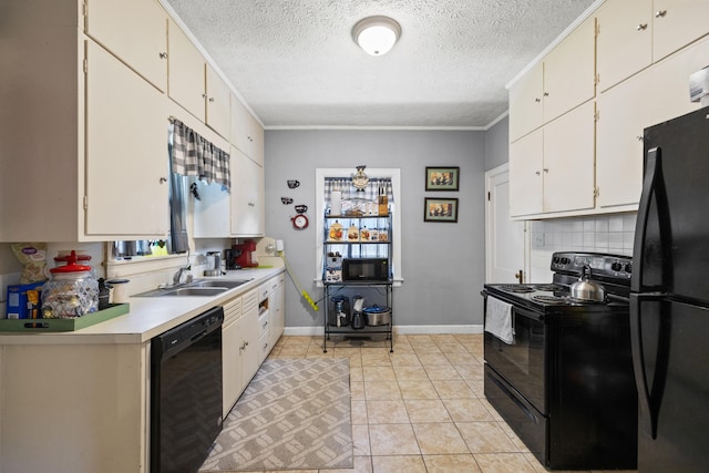 kitchen with a textured ceiling, a sink, light countertops, baseboards, and black appliances