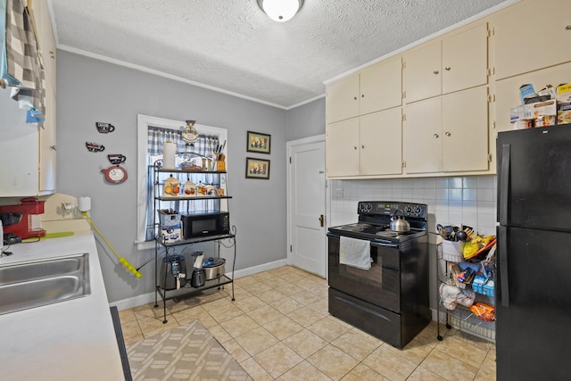 kitchen with backsplash, a textured ceiling, a sink, black appliances, and cream cabinetry