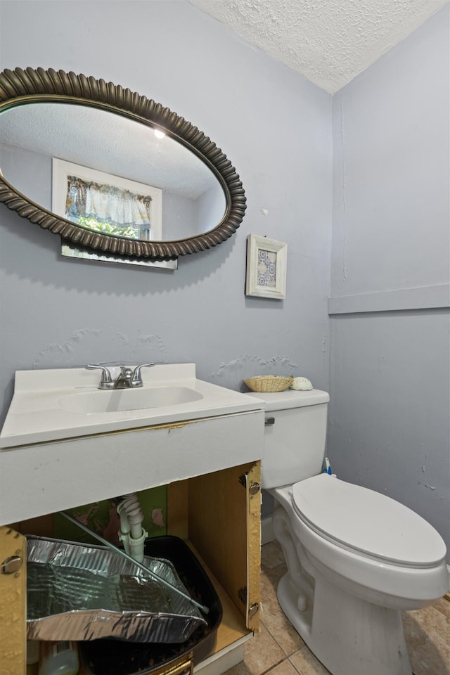 bathroom with vanity, tile patterned floors, toilet, and a textured ceiling