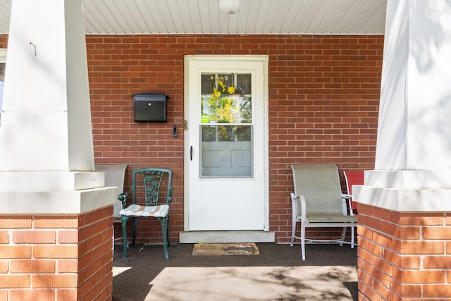 property entrance with brick siding