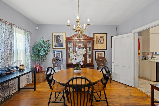 dining room featuring an inviting chandelier and hardwood / wood-style flooring