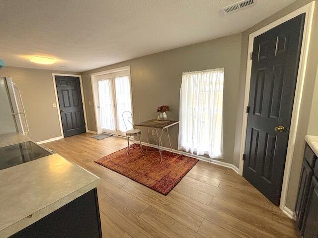 entrance foyer featuring baseboards, light wood-style flooring, and visible vents