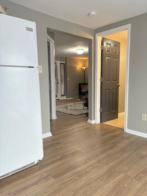 interior space with light wood-style floors and baseboards