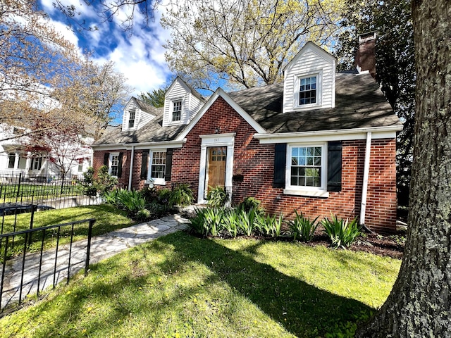 847 W Lexington Ave, Danville, KY 40422 - cape cod-style house featuring a front lawn, a chimney, fence, brick siding, and a shingled roof