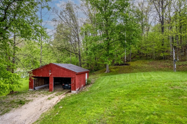 1132 State Highway 1662, Olive Hill, KY 41164 - view of yard featuring driveway, an outbuilding, a wooded view, a pole building, and a garage