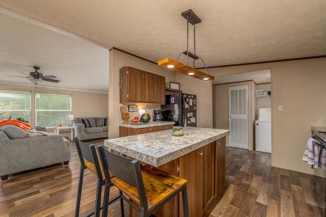 1132 State Highway 1662, Olive Hill, KY 41164 - kitchen featuring freestanding refrigerator, washer / clothes dryer, brown cabinetry, dark wood-type flooring, and light countertops