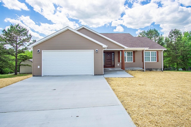 single story home featuring a garage, covered porch, a front yard, and concrete driveway