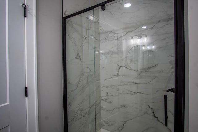 full bathroom featuring a marble finish shower