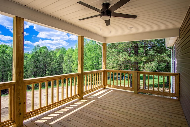 wooden deck featuring a ceiling fan