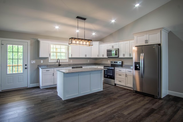 kitchen with white cabinetry, appliances with stainless steel finishes, lofted ceiling, and a sink