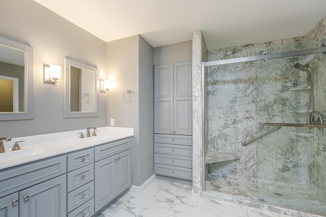 bathroom featuring a shower stall, marble look tiles, double vanity, and baseboards