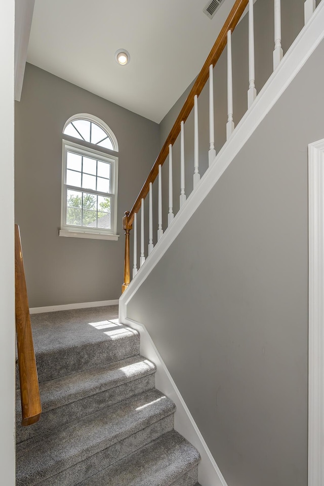 stairway featuring baseboards, carpet, and recessed lighting