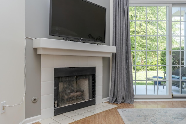 detailed view of a fireplace and wood finished floors