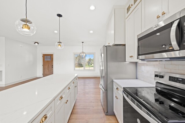 35 Valley Pointe Dr, Somerset, KY 42501 - kitchen with white cabinets, light wood-style floors, appliances with stainless steel finishes, and decorative backsplash