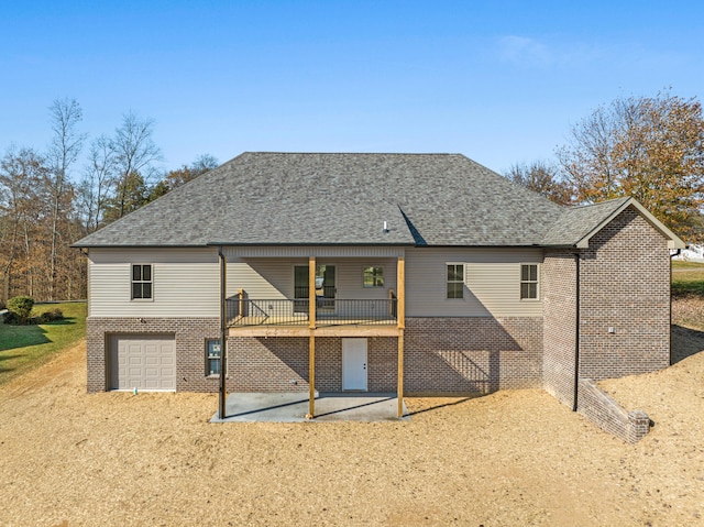 35 Valley Pointe Dr, Somerset, KY 42501 - back of house with brick siding, a patio, dirt driveway, roof with shingles, and an attached garage
