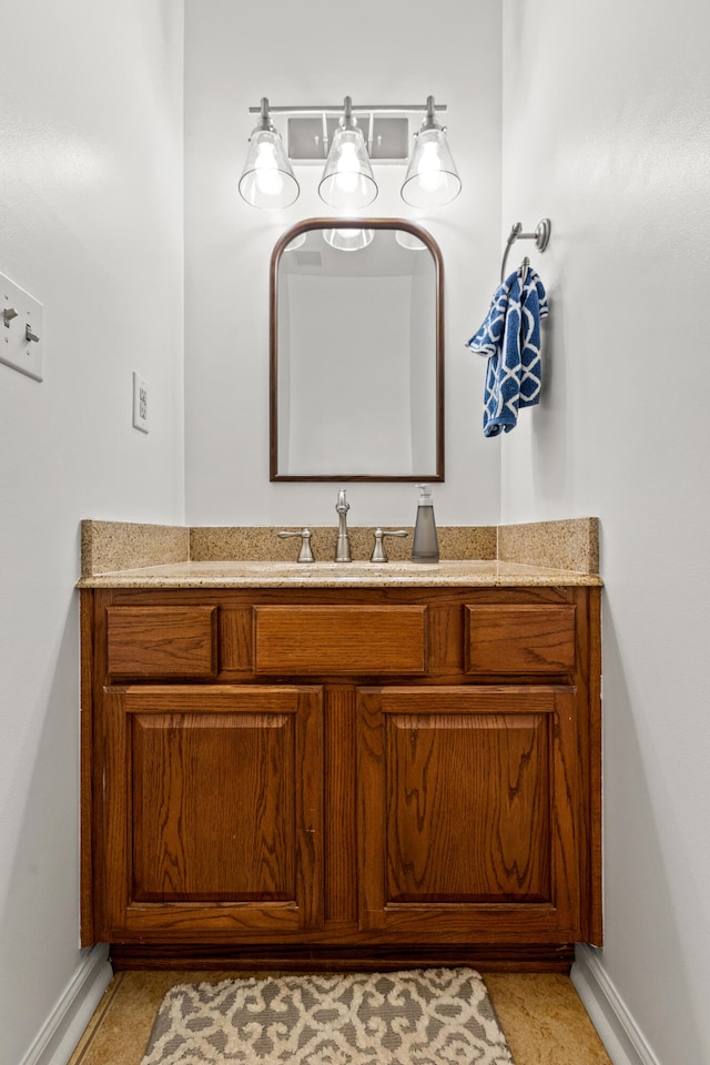 bathroom featuring baseboards and vanity