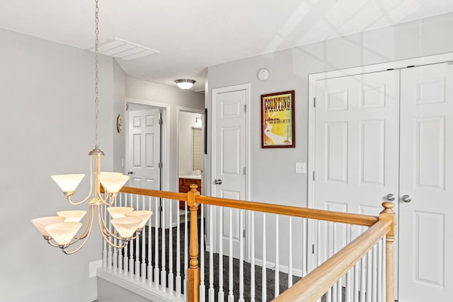 hallway featuring visible vents and an upstairs landing