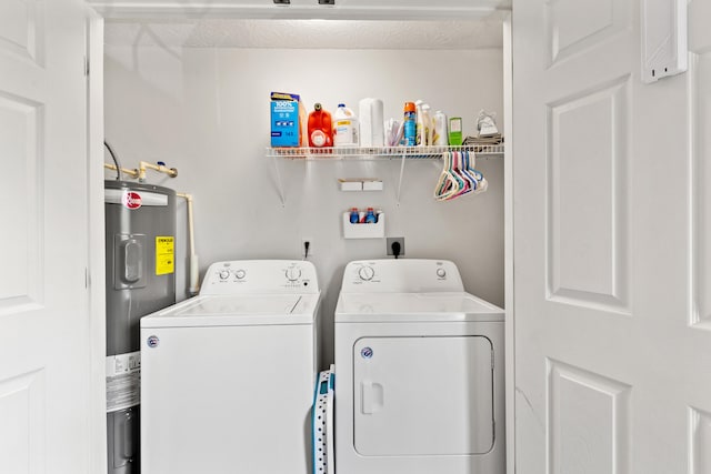 laundry area featuring washing machine and dryer, laundry area, and electric water heater