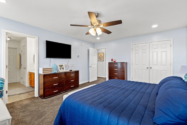 bedroom featuring recessed lighting, ensuite bath, light colored carpet, a closet, and a ceiling fan
