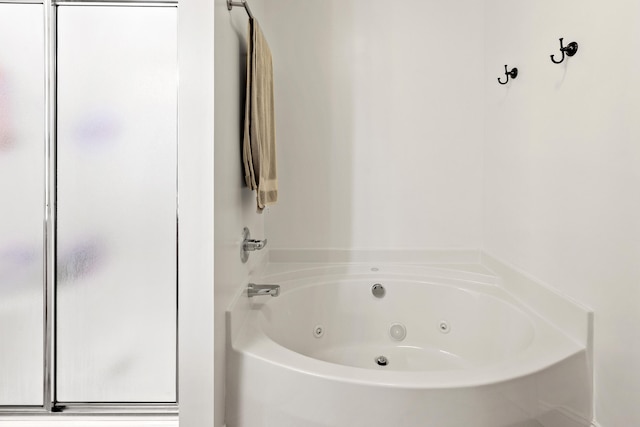 bathroom with a tub with jets