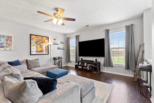 living room featuring baseboards, ceiling fan, wood-type flooring, and plenty of natural light