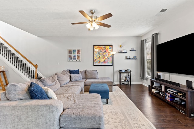 living area with stairs, ceiling fan, dark wood-style flooring, baseboards, and visible vents