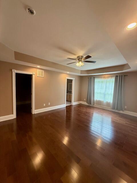 301 Lattern Way, Frenchburg, KY 40322 - empty room featuring baseboards, ceiling fan, dark wood-type flooring, and a tray ceiling