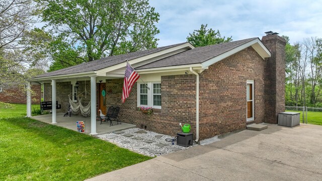 120 Grant Dr, Richmond, KY 40475 - exterior space with a chimney, fence, a yard, a patio, and brick siding