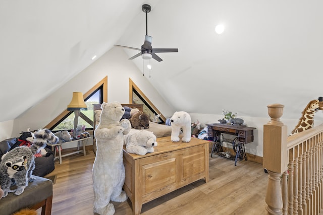 interior space featuring light wood finished floors, ceiling fan, lofted ceiling, and baseboards