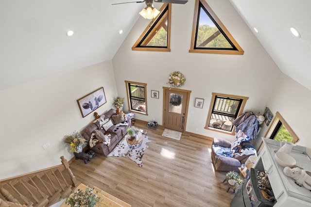 living area with light wood-style flooring, ceiling fan, recessed lighting, and high vaulted ceiling