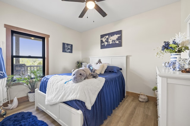 bedroom featuring a ceiling fan, light wood finished floors, and baseboards