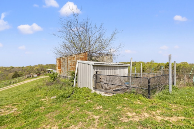 exterior space with an outbuilding and fence