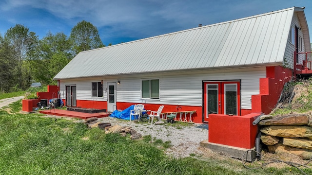 back of house with metal roof