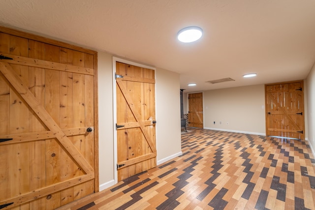 finished below grade area featuring baseboards, recessed lighting, and visible vents
