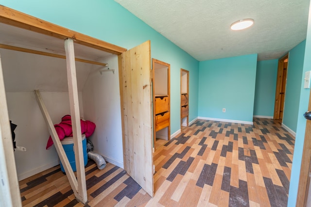 interior space with baseboards and a textured ceiling