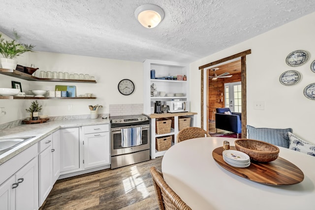 293 Deer Run Rd, Wellington, KY 40387 - kitchen featuring stainless steel electric stove, open shelves, white microwave, dark wood-style flooring, and light countertops