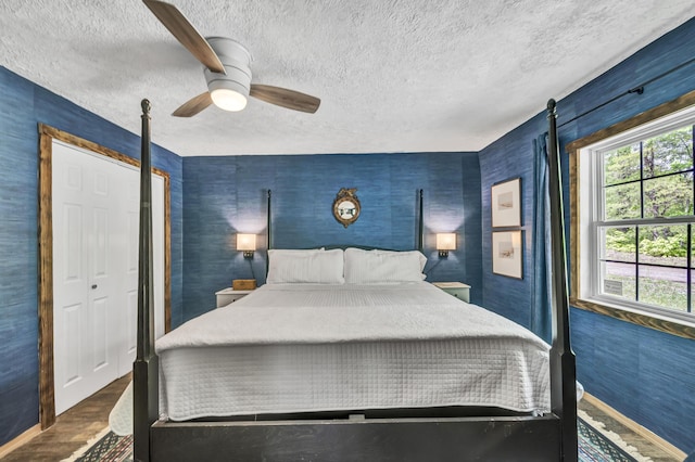 293 Deer Run Rd, Wellington, KY 40387 - bedroom featuring a textured ceiling, wood finished floors, ceiling fan, baseboards, and wallpapered walls