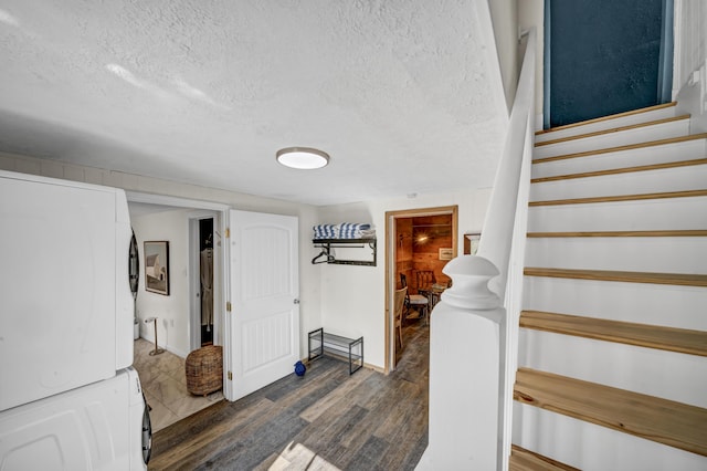 293 Deer Run Rd, Wellington, KY 40387 - stairs with stacked washer / drying machine, wood finished floors, a textured ceiling, and baseboards