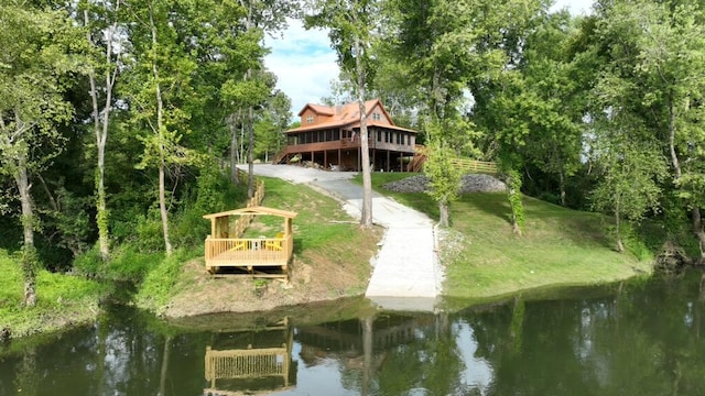 surrounding community with a deck with water view